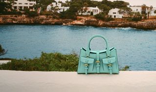 model wearing Mulberry mini Roxanne shoulder bag in sage green