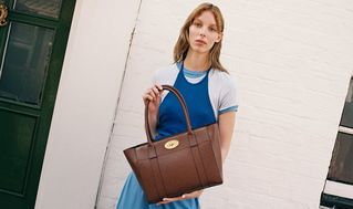 model wearing Mulberry Bayswater 9 to 5 bag in oak leather