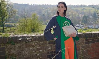 female model wearing Mulberry mini zipped Bayswater bag in cream leather