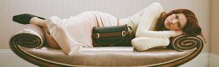 female model wearing Mulberry Bayswater bag in burgundy leather